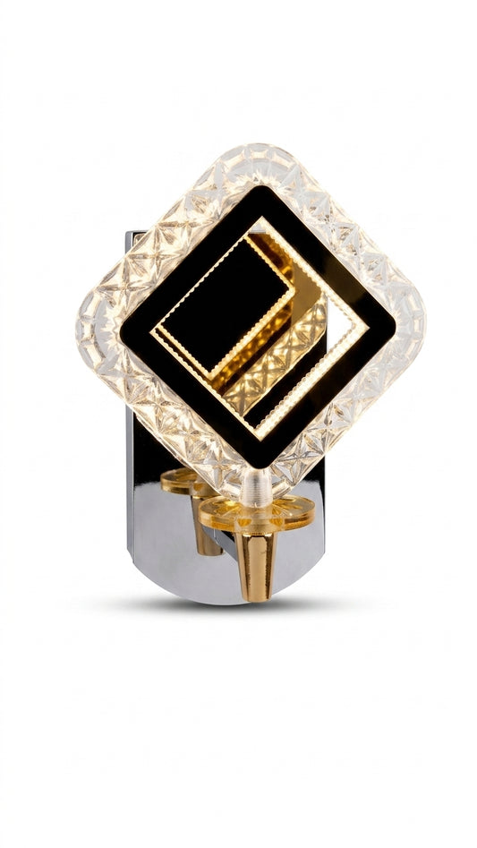 Crystal LED wall sconce with faceted diamond shade and chrome-and-gold base on white background