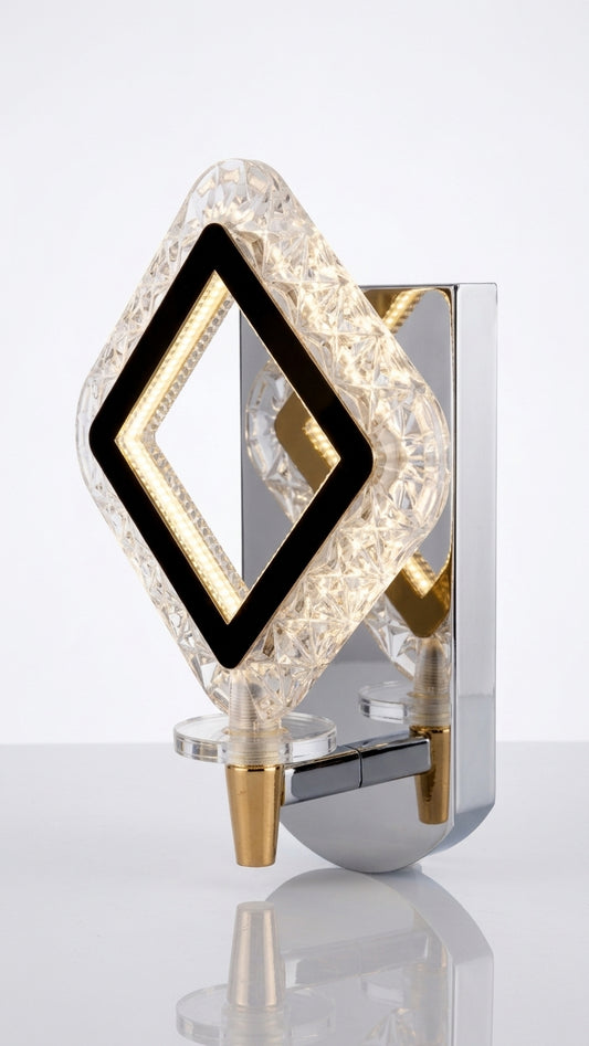 Crystal LED wall sconce with faceted diamond shade and chrome-and-gold base on white background from the side.