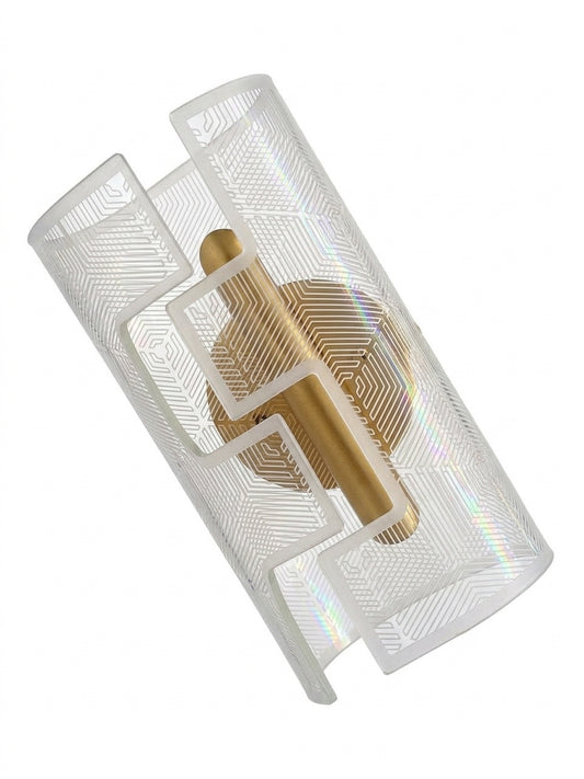 A modern wall sconce featuring a brushed gold brass central column and a clear, geometrically patterned cylindrical glass shade with iridescent rainbow reflections, shown on a solid white background.
