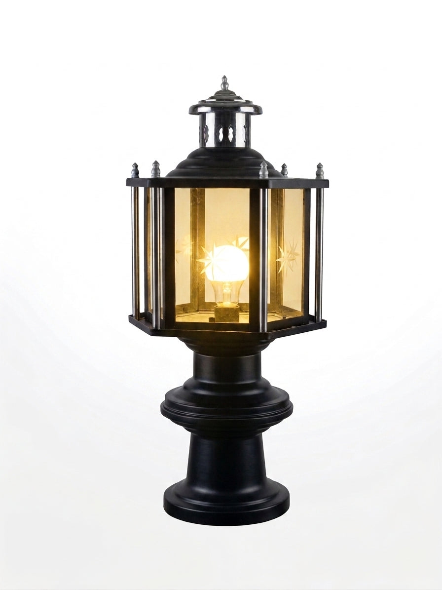 A classic outdoor post cap light fixture with a black metal frame and warm yellow glass panels, shown illuminated against a white background.