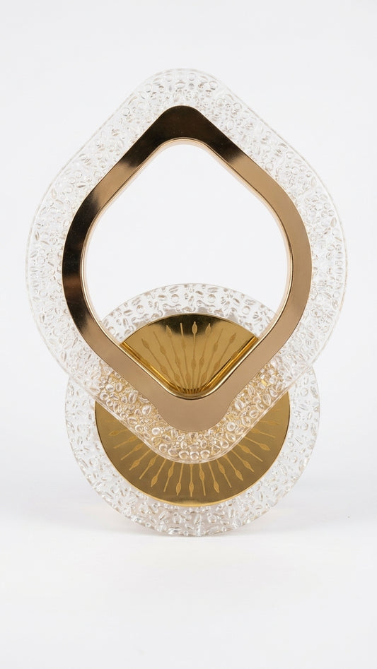 A decorative gold and clear textured glass sculpture on a seamless white background.