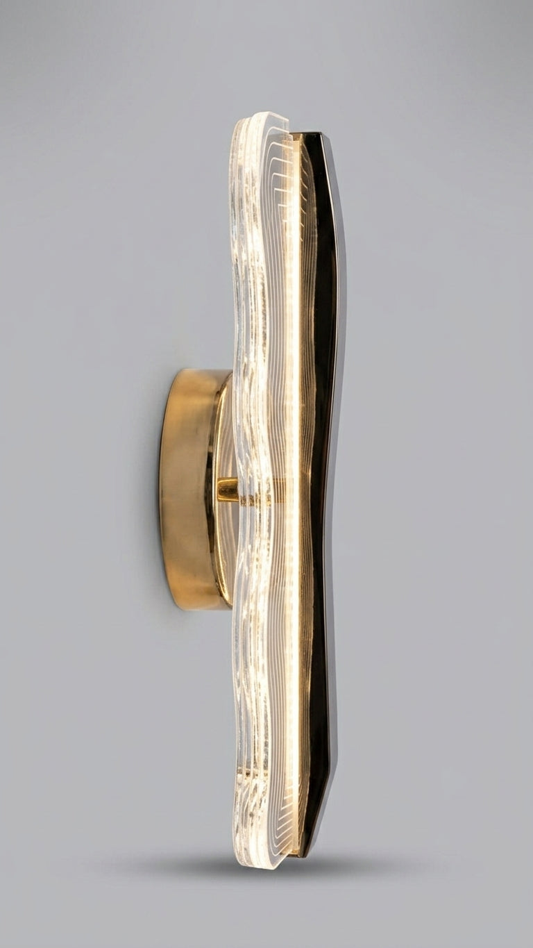 Waveform textured acrylic & gold LED wall sconce with rippled light-diffusing panel side profile.